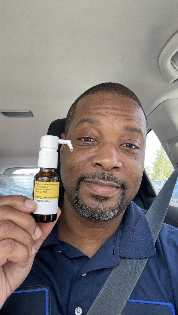 Curex member holding his allergy drops