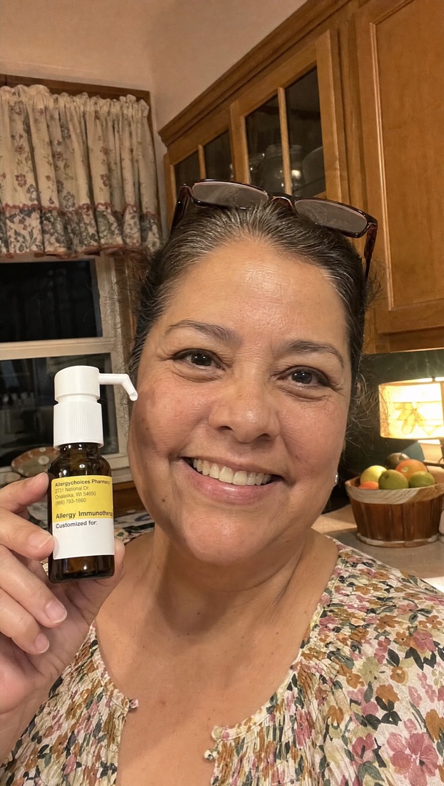 Curex member in her kitchen holding her drops