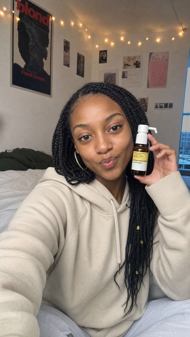 Curex member at home holding her allergy drops